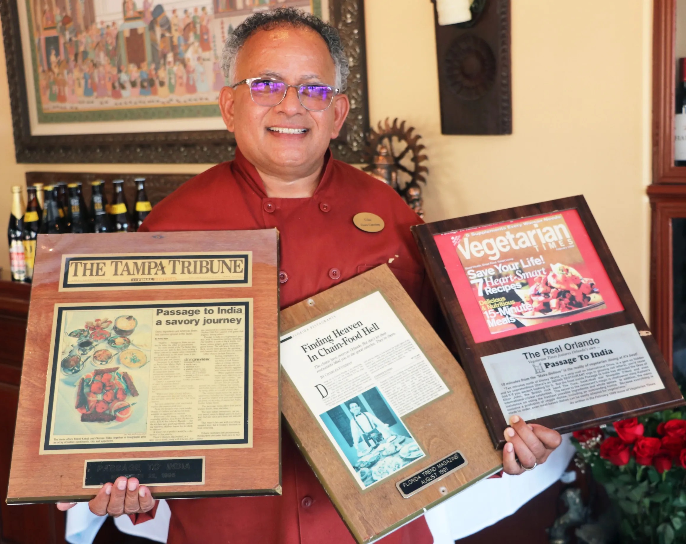 Chef holding awards given to Guru Restaurant