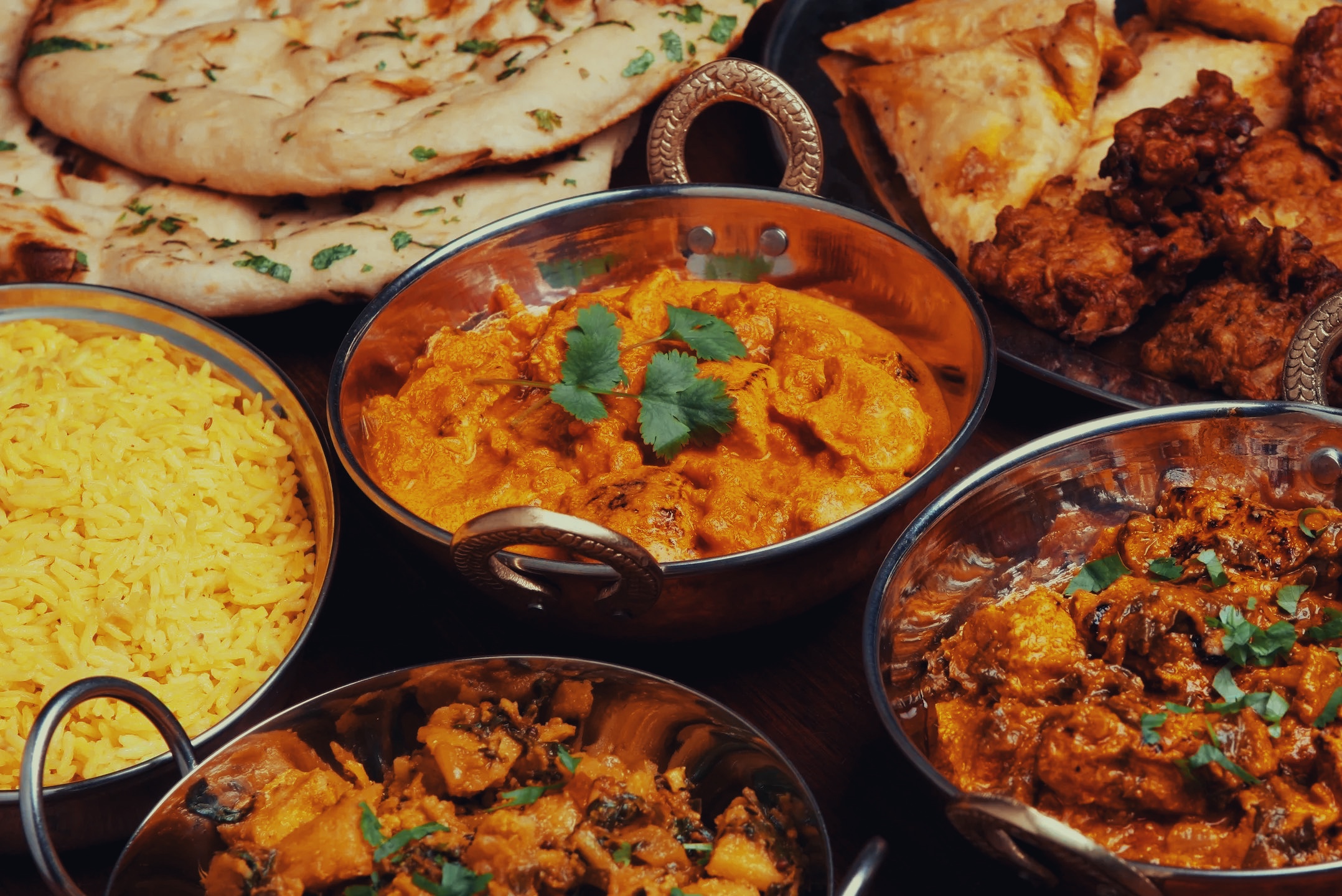 Dishes served at Guru including Naan Paneer Tikka Masala Samosa
